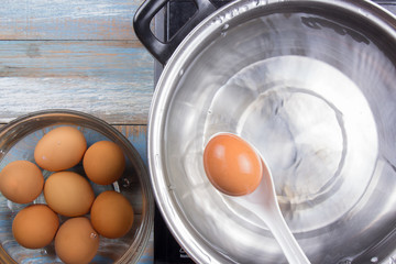 Chef putting boiled eggs  in cup