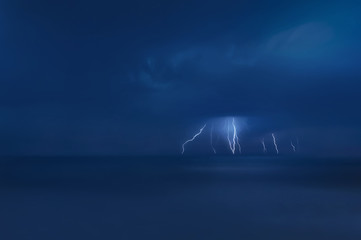 Summer storm, dramatic sky  and amazing lightnings over the ocean. natural background