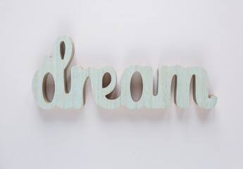 Dream - inspirational word at pastel pink background, typography for poster, t-shirt or card. flat...