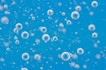 Fototapeta na wymiar Water blue structure. Bubbles of oxygen under water. Macro
