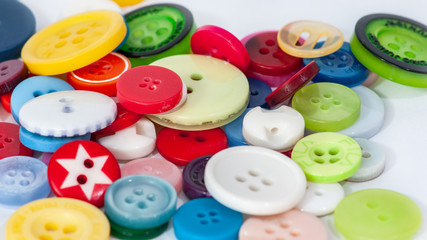 Buttons of different colours and sizes on a white background