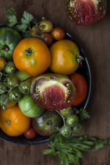 Colorful fresh tomatoes on vintage wooden background