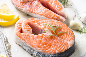 Salmon steak fresh fish with spices close up.