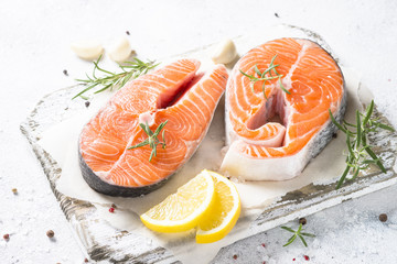 Salmon steak fresh fish with spices close up.