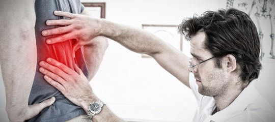 Composite image of side view of a male physiotherapist examining