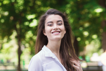 Portrait of beautiful young smiling woman outdoors