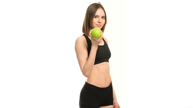Slim and healthy young woman holding an apple isolated on white background. Weight loss and diet concept.