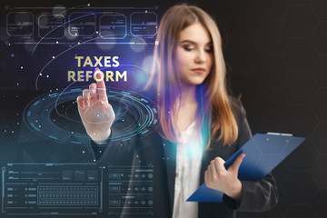 The concept of business, technology, the Internet and the network. A young entrepreneur working on a virtual screen of the future and sees the inscription: taxes reform