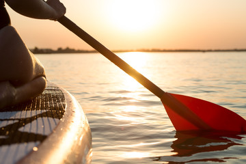 Young sexy woman swimming on stand up paddle board.Water sports , active lifestyle.