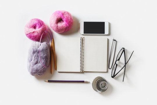 Yarn for knitting and stationery. Flat lay.