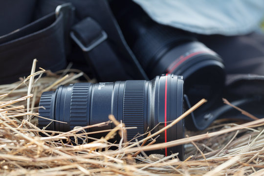 photographic lens is lying on a haystack, countryside protographer concept