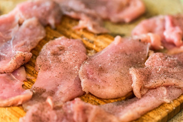 Pounded raw meat on wooden cutting board