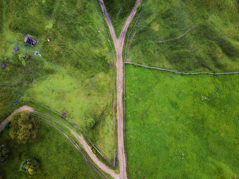 Arial Veiw Of Rural Road, Green Field And Trees. Drone Shot