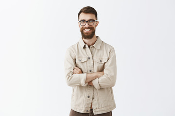 Portrait of charming enthusiastic mature guy with long beard and stylish hairstyle smiling broadly...