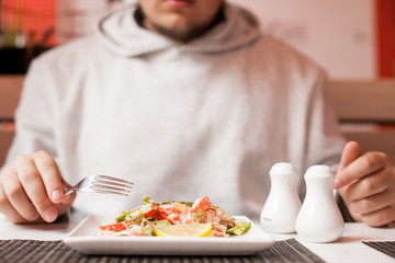 man eating japanese Shrimp Salad with cucumber, lime and caviar