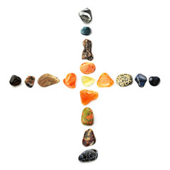 Cross of of semi-precious gemstones, isolated on white background