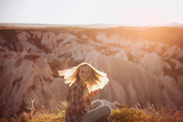 beautiful woman traveler at mountains on sunset. travel, lifestyle, instagram concept