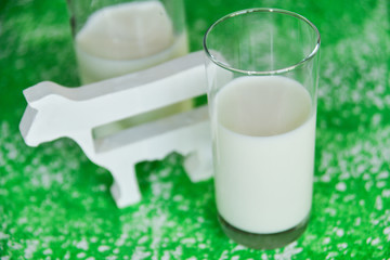 milk bottle, glass of milk, a figure of a cow the concept of rural food, fresh food