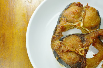 fried salty striped catfish slice on white dish