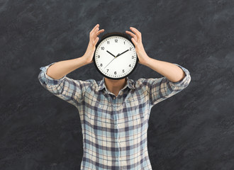 Man holding clock instead of head