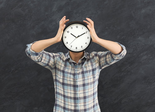Man holding clock instead of head
