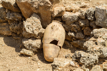 Old jug near stone wall, archaeological park of Shiloh, Israel