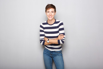 smiling young woman with short hair against gray background