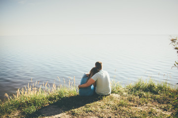 Naklejka na ściany i meble couple is hugging sitting to the sun