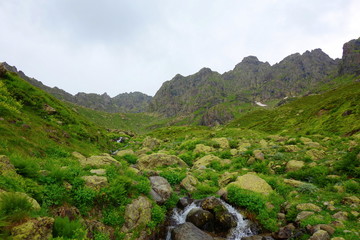 Fototapeta na wymiar View at Tsashkibuli mountain pass in Caucasus Mountains on a hiking trail leading to Silver lakes in Georgia