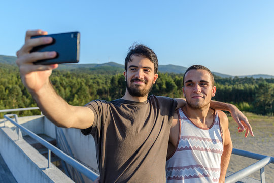 two young guys are doing selfie