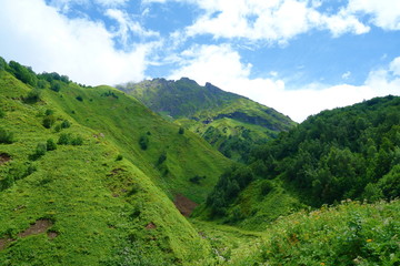 Fototapeta na wymiar Hiking trail to Silver lakes with clouds around the mountains going via Tobavarchkhili from Mukhuri to Khaishi in Caucasus mountains, Georgia