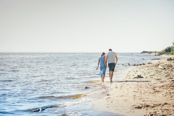 Fototapeta na wymiar Happy couple running on the beach
