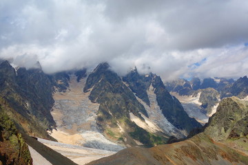 Mount Ushba glacier covered partially by clouds in Caucasus Mountains, Upper Svaneti region in Georgia