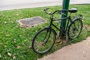 Fototapeta premium old bicycle parked by footpath