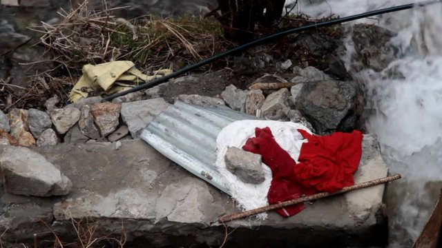 The clothes and washboard are prepared by a mountain woman for washing on the shore of the mountain stream, manual washing. India

