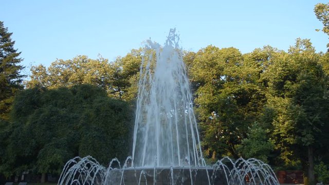 Fountain in a public park changing shapes of spraying water, in Vrnjacka Banja, Serbia, in the morning