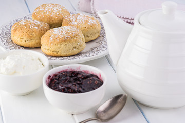 Traditional English cream tea. English scones with clotted cream and raspberry jam.