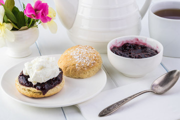 Traditional English cream tea. English scones with clotted cream and raspberry jam.