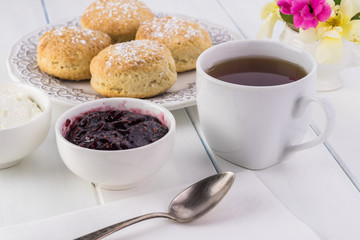 Traditional English cream tea. English scones with clotted cream and raspberry jam.
