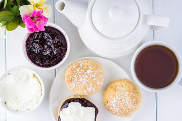 Fototapeta na wymiar Traditional English cream tea. English scones with clotted cream and raspberry jam.