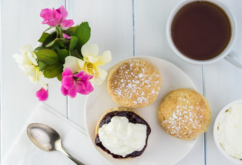 Traditional English cream tea. English scones with clotted cream and raspberry jam.