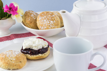 Traditional English cream tea. English scones with clotted cream ans raspberry jam.