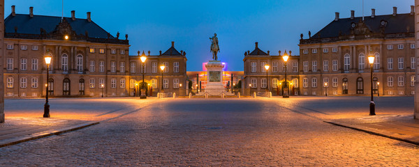 Statue of Frederick V at the centre of the Amalienborg Palace Square and Amalienborg Palace in Copenhagen, capital of Denmark. Panoramic night view.