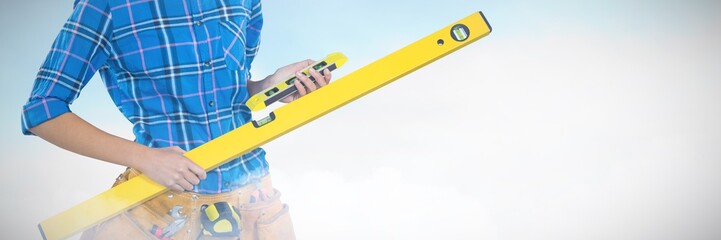 Composite image of female architect holding measuring equipment