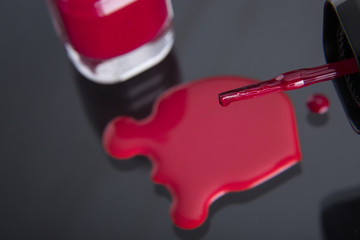 Brush detail of a nail varnish with drop /  Close up of the brush of a nail polish with poured nail polish and glass flask