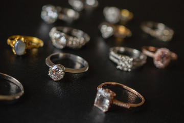 Jewelry diamond rings on black background close up