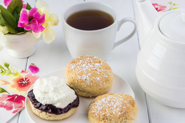 Traditional English cream tea. English scones with clotted cream and raspberry jam.