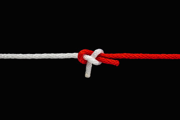 Tie the knot with red and white rope on black background with clipping path