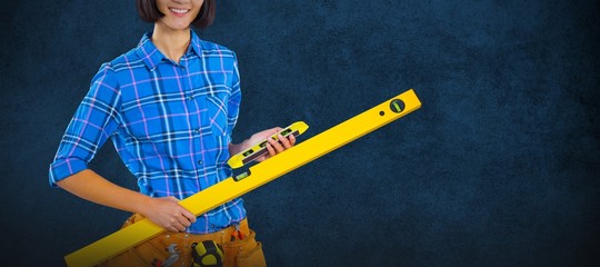 Composite image of female architect holding measuring equipment