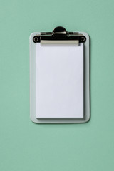 Clipboard mockup on turquoise background. Flat lay, top view trendy for banner